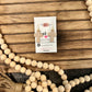 NUDE CROSS DANGLE